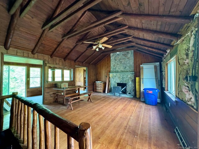 living room featuring wood ceiling, a fireplace, lofted ceiling with beams, wood walls, and hardwood / wood-style flooring