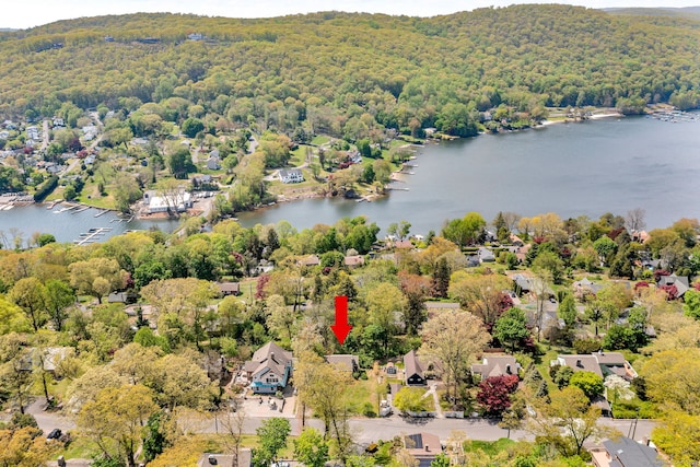bird's eye view with a wooded view, a water view, and a residential view