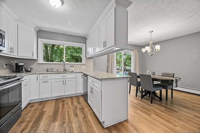 333 Vincellette St Unit 25, Bridgeport, CT 06606 - kitchen featuring stainless steel appliances, light wood-style flooring, tasteful backsplash, and a chandelier