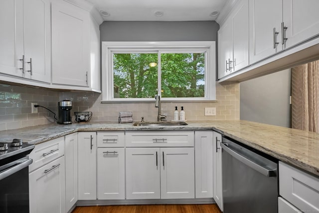 333 Vincellette St Unit 25, Bridgeport, CT 06606 - kitchen featuring stainless steel appliances, a sink, white cabinetry, and decorative backsplash