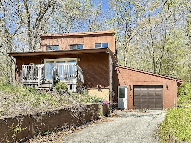 view of front facade with a porch, a garage, and driveway