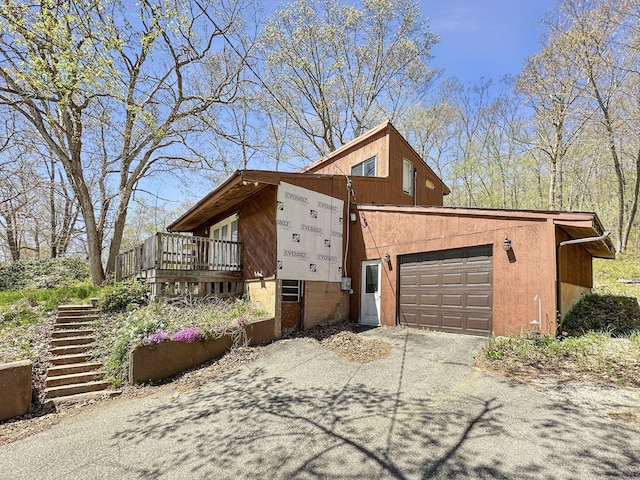 view of property exterior with driveway and a garage