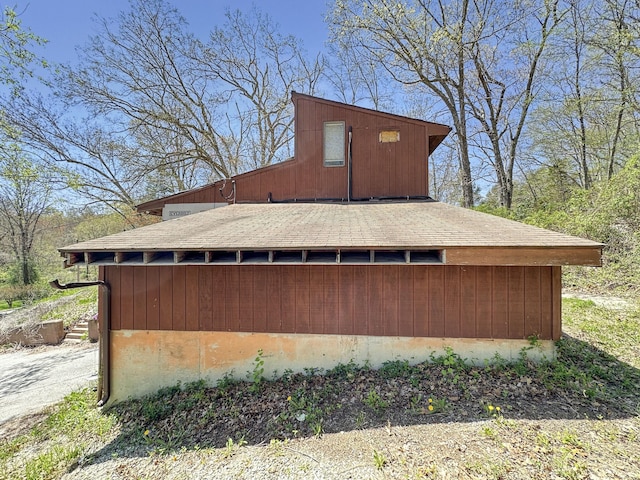 view of home's exterior with a shingled roof