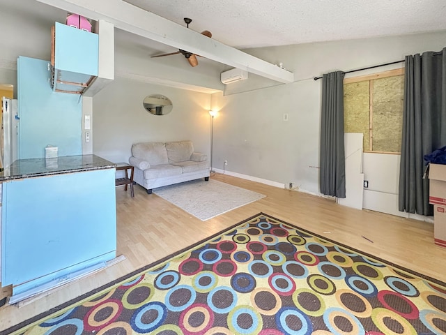 unfurnished living room featuring a wall mounted air conditioner, a textured ceiling, lofted ceiling, and wood finished floors