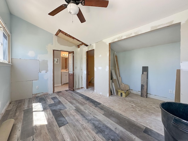 spare room featuring a ceiling fan, wood finished floors, and lofted ceiling