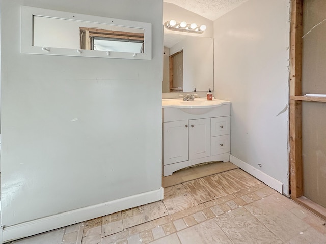 bathroom featuring baseboards and vanity