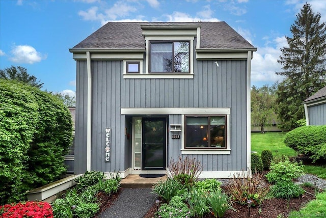 view of front of property featuring roof with shingles