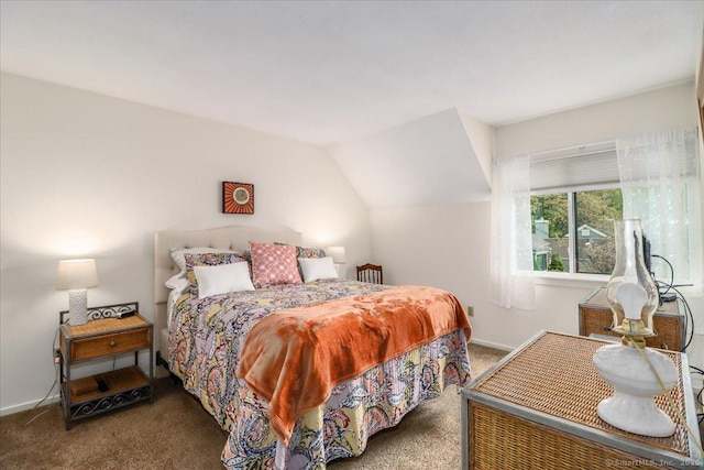 carpeted bedroom with baseboards and vaulted ceiling