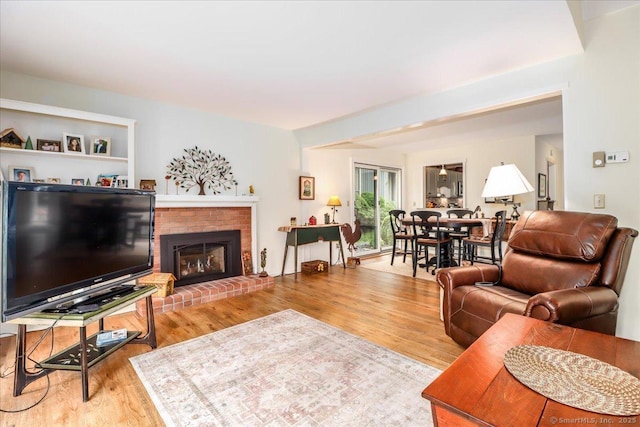 living area with wood finished floors and a fireplace