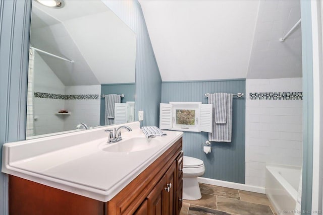 bathroom featuring baseboards, toilet, vanity, vaulted ceiling, and  shower combination
