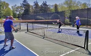 view of tennis court with fence