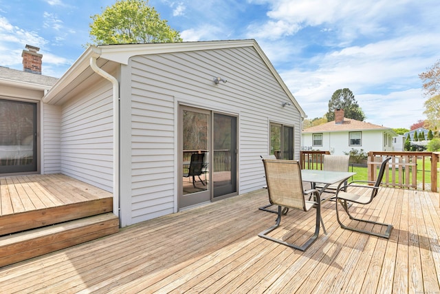 wooden terrace with outdoor dining area