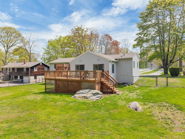 back of property with stairs, a deck, a fenced backyard, a gate, and a yard