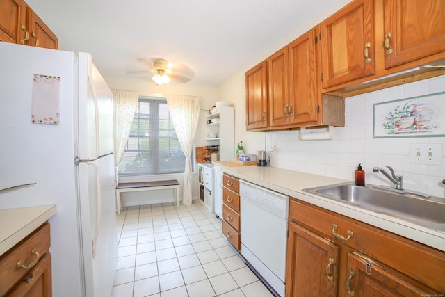 kitchen featuring a ceiling fan, light tile patterned floors, white appliances, brown cabinets, and light countertops