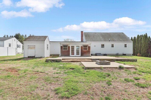 327 Abbe Rd, Enfield, CT 06082 - rear view of property with a chimney, french doors, a patio, a lawn, and a fire pit