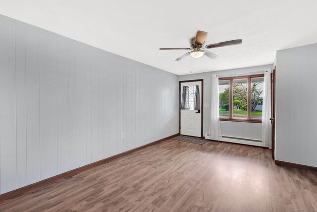 327 Abbe Rd, Enfield, CT 06082 - empty room with baseboards, ceiling fan, a baseboard heating unit, and wood finished floors