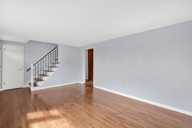 327 Abbe Rd, Enfield, CT 06082 - unfurnished living room with baseboards, stairs, and wood finished floors