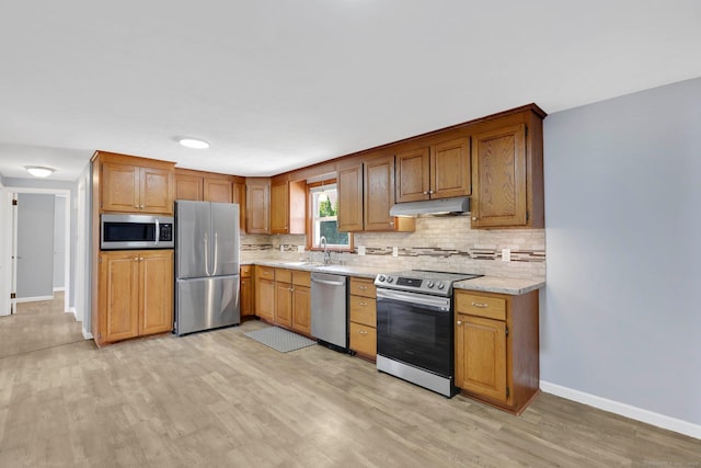 327 Abbe Rd, Enfield, CT 06082 - kitchen with decorative backsplash, baseboards, light wood finished floors, under cabinet range hood, and stainless steel appliances
