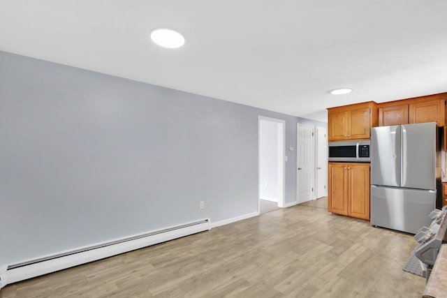 327 Abbe Rd, Enfield, CT 06082 - kitchen with light wood finished floors, brown cabinetry, stainless steel appliances, baseboards, and a baseboard radiator