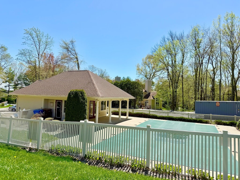 pool with a patio area and fence