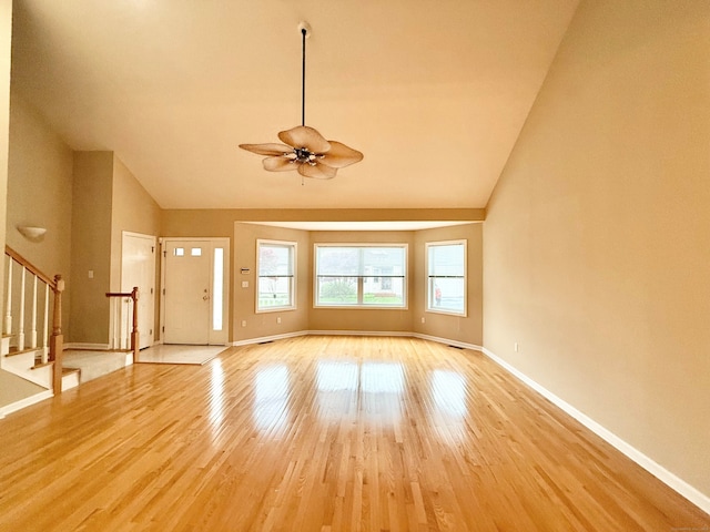253 Summerfield Gdns Unit 253, Shelton, CT 06484 - entryway with a ceiling fan, stairway, light wood-style floors, baseboards, and high vaulted ceiling