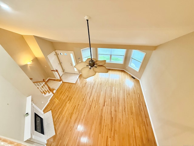 253 Summerfield Gdns Unit 253, Shelton, CT 06484 - unfurnished living room featuring wood finished floors, baseboards, and a multi sided fireplace