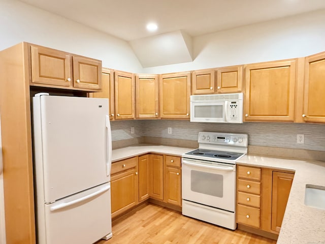 253 Summerfield Gdns Unit 253, Shelton, CT 06484 - kitchen with white appliances, light countertops, backsplash, light wood-style floors, and lofted ceiling