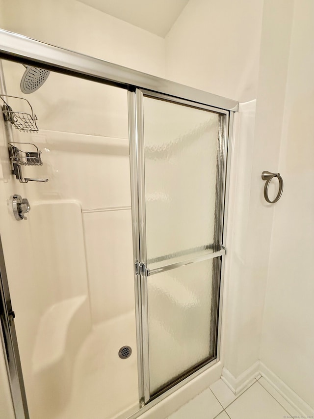 253 Summerfield Gdns Unit 253, Shelton, CT 06484 - bathroom featuring a stall shower, tile patterned floors, and baseboards