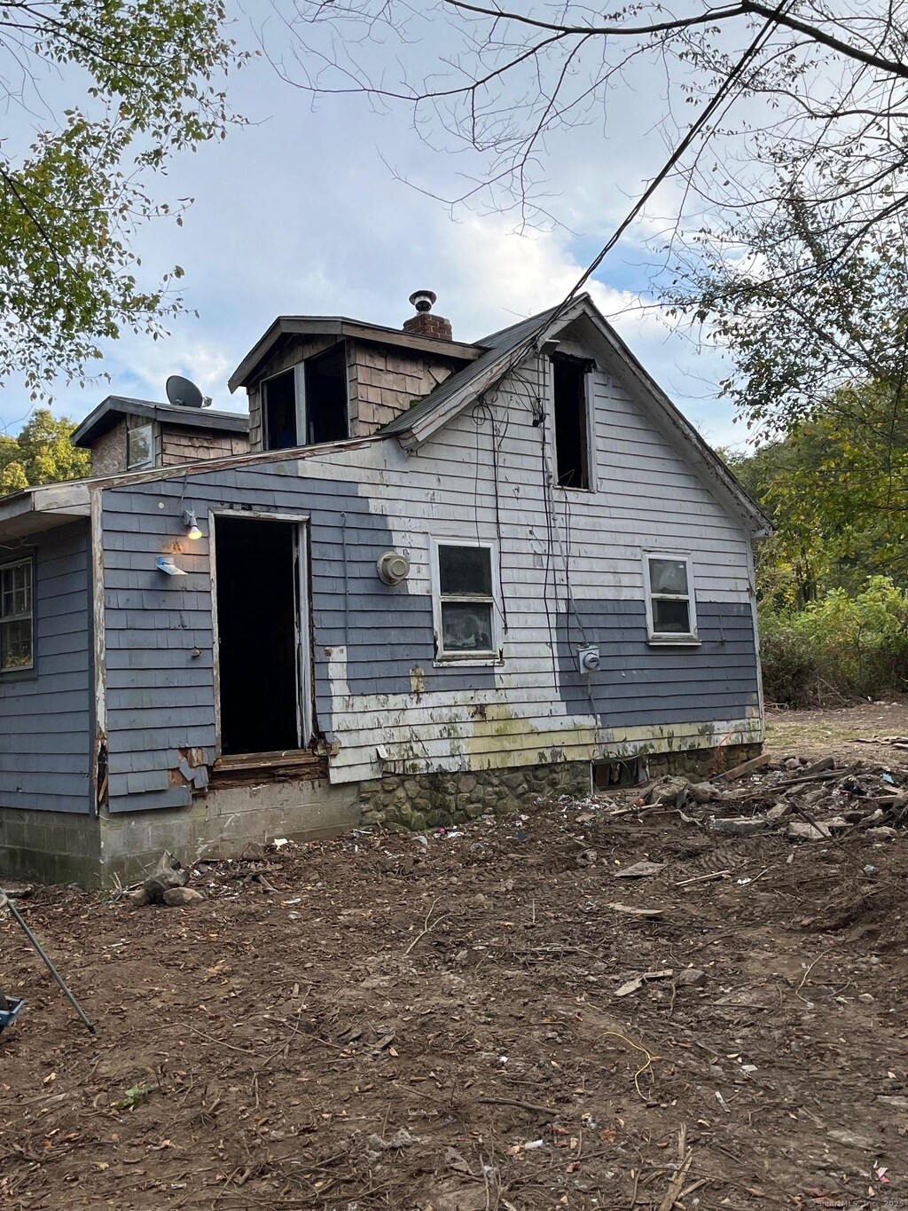 back of property featuring a chimney and entry steps