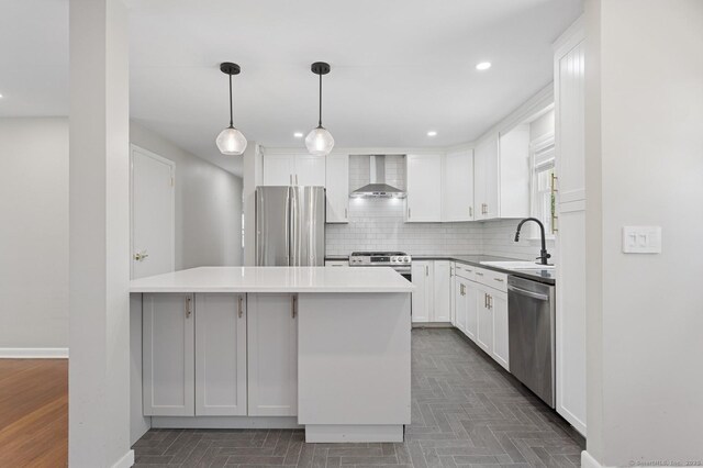 128 W Ave, Darien, CT 06820 - kitchen featuring stainless steel appliances, wall chimney exhaust hood, a sink, tasteful backsplash, and white cabinets