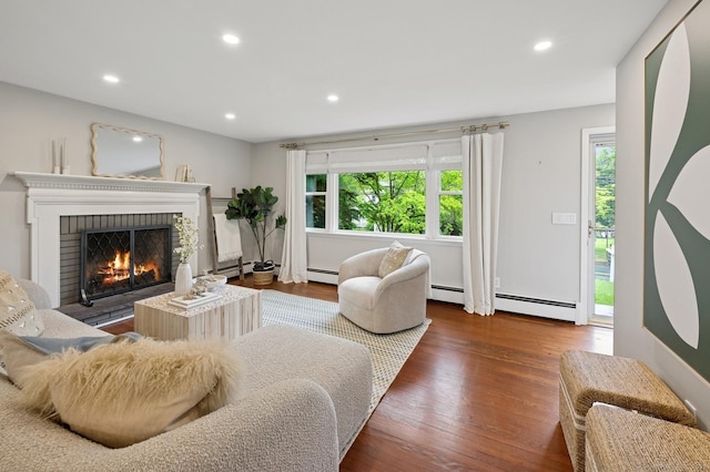 128 W Ave, Darien, CT 06820 - living room with healthy amount of natural light, baseboard heating, a brick fireplace, and recessed lighting