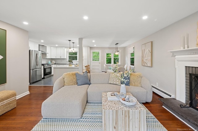 128 W Ave, Darien, CT 06820 - living area with a baseboard heating unit, recessed lighting, dark wood-style floors, a fireplace, and baseboards
