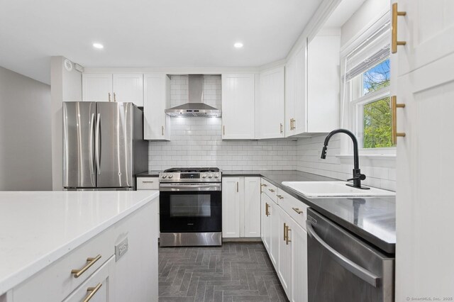 128 W Ave, Darien, CT 06820 - kitchen with stainless steel appliances, wall chimney exhaust hood, a sink, white cabinets, and decorative backsplash