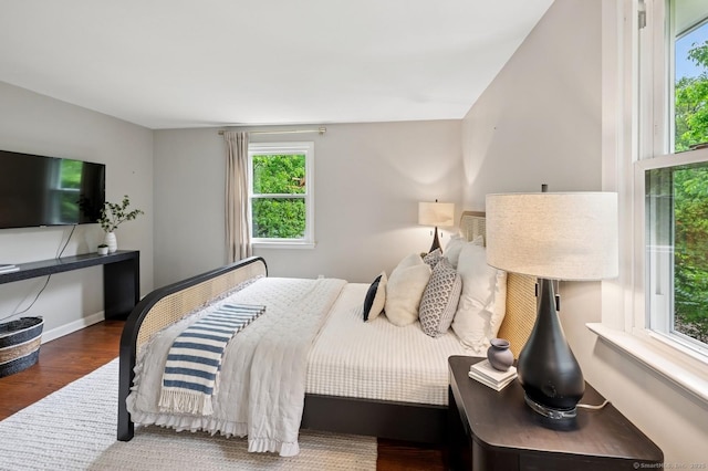 128 W Ave, Darien, CT 06820 - bedroom with wood finished floors, multiple windows, and baseboards