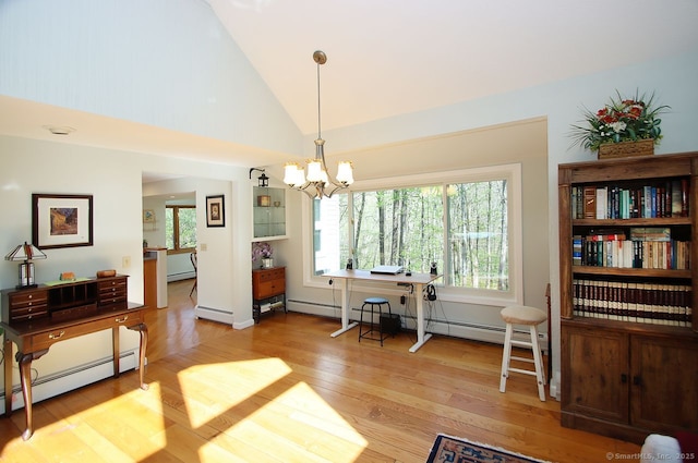 dining area featuring baseboard heating, a chandelier, plenty of natural light, and light wood-style flooring