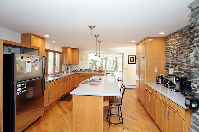 kitchen with light wood-style floors, freestanding refrigerator, and a healthy amount of sunlight