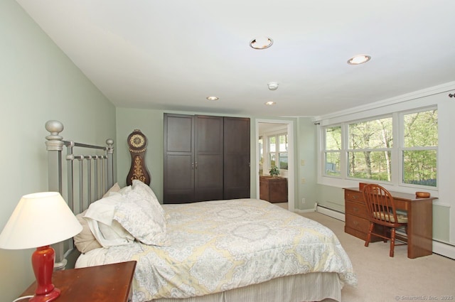 bedroom with a baseboard radiator, light carpet, a closet, and recessed lighting