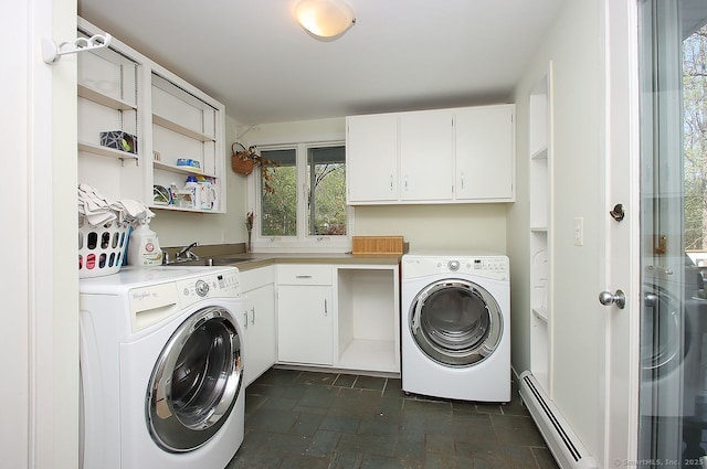 laundry area with cabinet space, a baseboard heating unit, and a sink