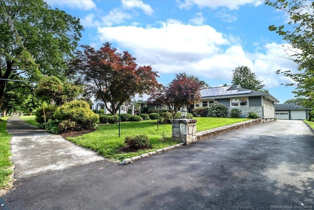 110 Deer Hill Ave, Danbury, CT 06810 - view of front of home with a front yard, a garage, an outdoor structure, and solar panels