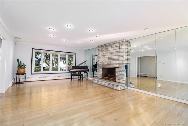 110 Deer Hill Ave, Danbury, CT 06810 - living area with baseboard heating, light wood-style floors, crown molding, a stone fireplace, and recessed lighting