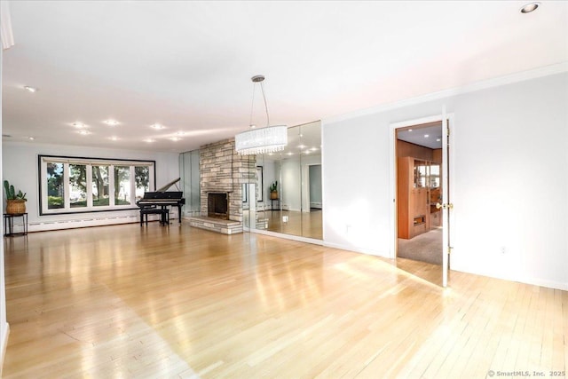110 Deer Hill Ave, Danbury, CT 06810 - unfurnished living room featuring hardwood / wood-style floors, a baseboard radiator, a stone fireplace, and crown molding