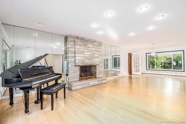 110 Deer Hill Ave, Danbury, CT 06810 - living room featuring wood finished floors, a stone fireplace, and recessed lighting