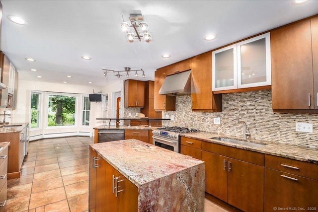 110 Deer Hill Ave, Danbury, CT 06810 - kitchen featuring under cabinet range hood, appliances with stainless steel finishes, a sink, brown cabinetry, and decorative backsplash