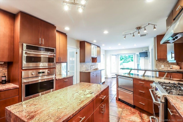 110 Deer Hill Ave, Danbury, CT 06810 - kitchen with stainless steel appliances, tasteful backsplash, under cabinet range hood, light stone counters, and recessed lighting