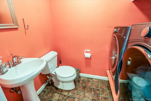 110 Deer Hill Ave, Danbury, CT 06810 - bathroom featuring washer / dryer, baseboards, and toilet