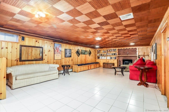 110 Deer Hill Ave, Danbury, CT 06810 - living room with wooden walls, a fireplace, baseboard heating, and tile patterned flooring