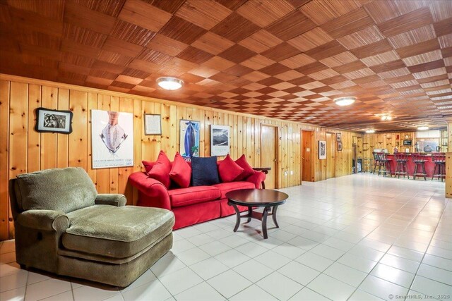 110 Deer Hill Ave, Danbury, CT 06810 - tiled living room with wood walls and bar area