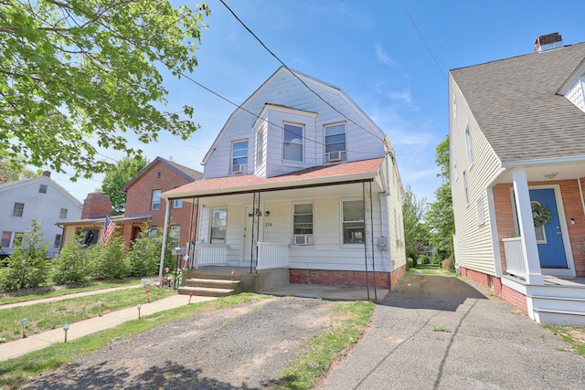 224 1st Ave, West Haven, CT 06516 - view of front facade with a gambrel roof, a porch, and driveway