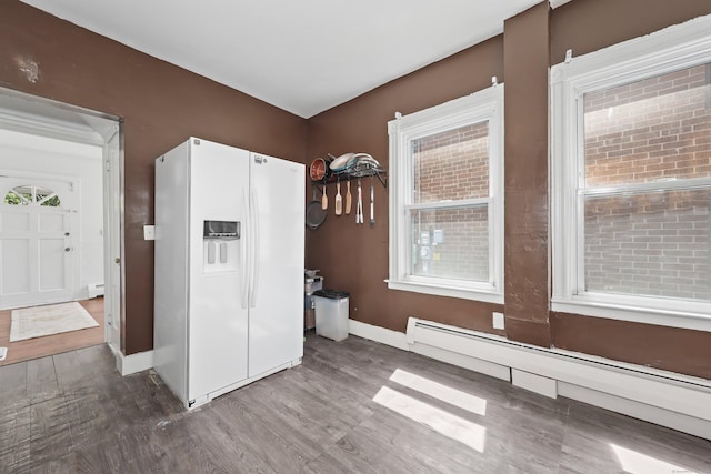 224 1st Ave, West Haven, CT 06516 - empty room featuring baseboard heating, wood finished floors, baseboards, a baseboard heating unit, and plenty of natural light