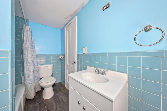 224 1st Ave, West Haven, CT 06516 - full bathroom featuring tile walls, wood finished floors, toilet, vanity, and wainscoting